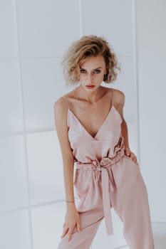 Portrait of a beautiful woman in a pink jumpsuit