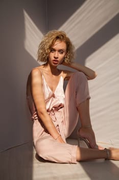 Portrait of a beautiful woman in a pink jumpsuit