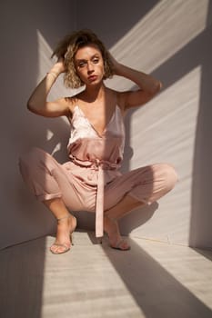 Portrait of a beautiful woman in a pink jumpsuit