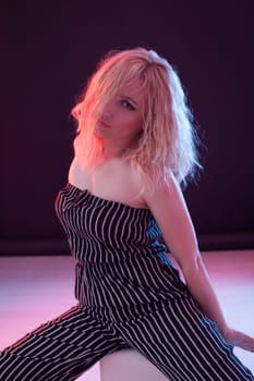 Portrait of a beautiful blonde woman in striped clothes