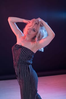 Portrait of a beautiful blonde woman in striped clothes