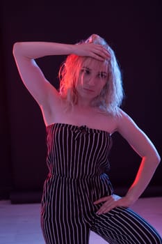 Portrait of a beautiful blonde woman in striped clothes