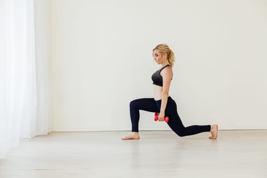 Blonde woman engaged in argument in the gym with fitness dumbbells