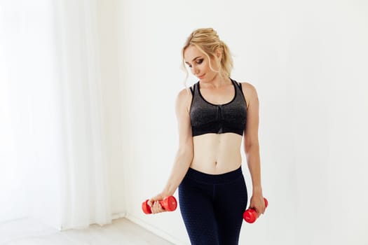 Blonde woman engaged in argument in the gym with fitness dumbbells