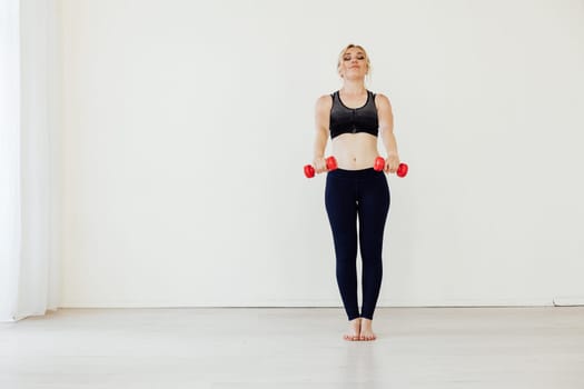 Blonde woman engaged in argument in the gym with fitness dumbbells