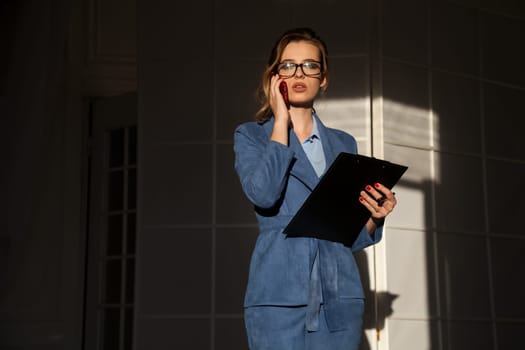 portrait of a beautiful fashionable woman in a business suit in the office at work