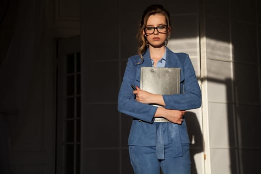 portrait of a beautiful fashionable woman in a business suit in the office at work