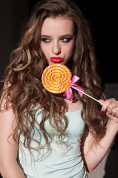 woman eats a big candy sweet lollipop