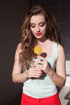 woman eats a big candy sweet lollipop