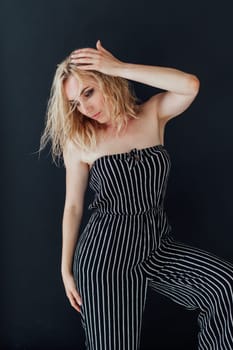 Portrait of a fashionable blonde woman in striped clothes