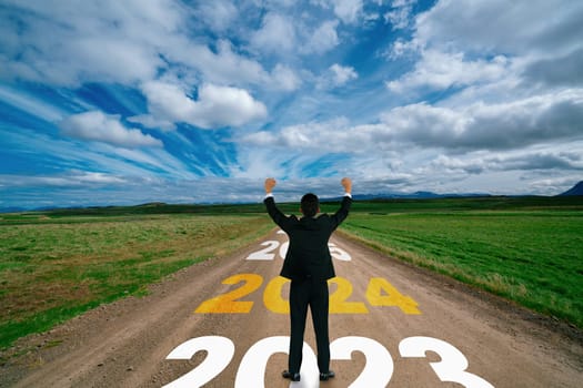 2024 New Year journey and future vision concept . Businessman traveling on highway road leading forward to happy new year celebration in beginning of 2024 for bliss and successful start .