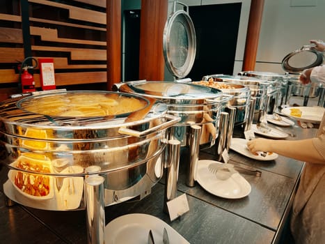 In the hotel buffet, there are multiple machines for keeping food warm, all lined up.
