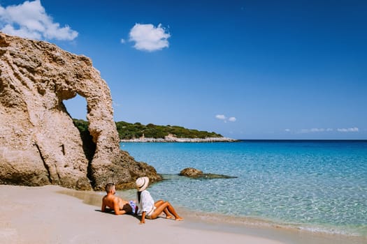 Tropical beach of Voulisma beach, Istron, Crete, Greece,Most beautiful beaches of Crete island -Istron bay near Agios Nikolaos young couple mid age on vacation in Greece Crete