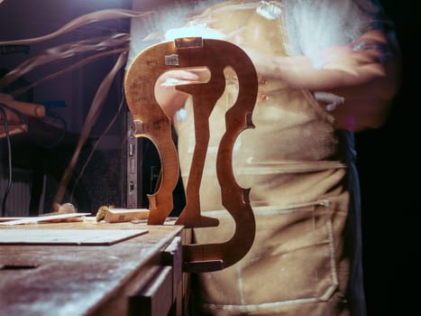 High quality photoartisan violin maker luthier working with violin mould for center bot, corner blocks , bend ribs for a handmade violin