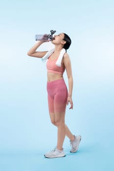 Athletic and sporty asian woman resting and drink water after intensive cardio workout training. Healthy exercising and fit body care lifestyle pursuit in studio shot isolated background. Vigorous