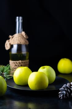 A ripe green apple fruits on a dark stone table. Top view with copy space. Flat lay