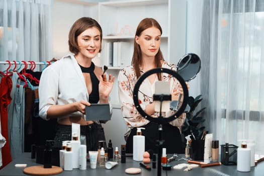 Woman influencer shoot live streaming vlog video review makeup utmost social media or blog. Happy young girl with cosmetics studio lighting for marketing recording session broadcasting online.