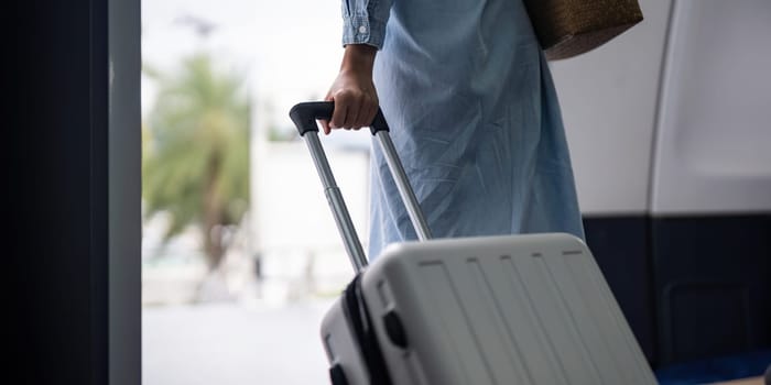 Young woman tourist with a suitcase at the airplane with a suitcase at the airplane.