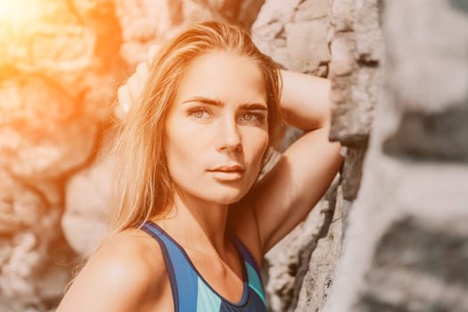 Woman travel sea. Young Happy woman in a long red dress posing on a beach near the sea on background of volcanic rocks, like in Iceland, sharing travel adventure journey