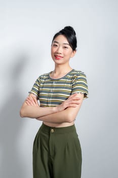 Portrait of Young beautiful Asian woman standing and smiling isolated on white background, Looking at camera