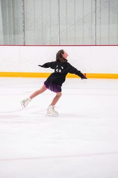 Little girl practicing before her figure skating competition at the indoor ice rink.