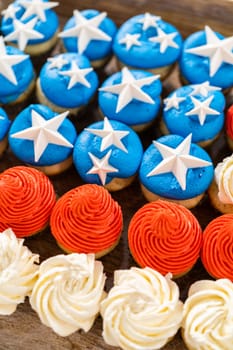 Arranging mini vanilla cupcakes in the shape of the American flag.