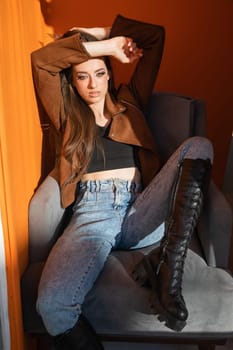 Beautiful brunette woman sun on orange