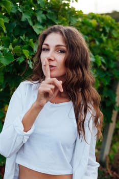 Woman holding finger to mouth silence