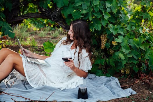 woman with a glass of wine in a vineyard