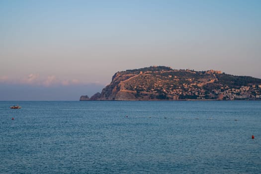 Beautiful sunrise scene on Alanya beach with view to famous Alanya island, in Turkey