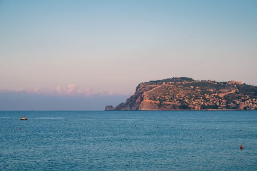 Beautiful sunrise scene on Alanya beach with view to famous Alanya island, in Turkey