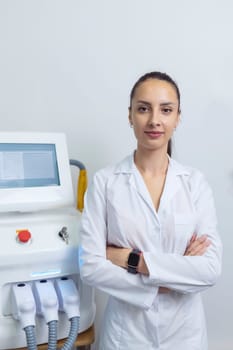 Doctor specialist beautician stands near the laser hair removal device.