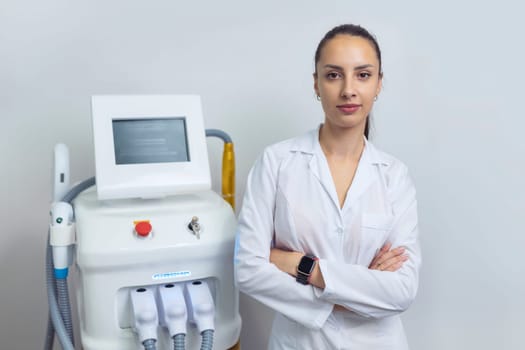 Doctor specialist beautician stands near the laser hair removal device.