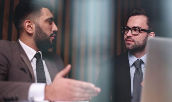 Business man having a discussion with his colleague in an office