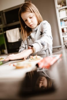 Little girl making breakfast at home.