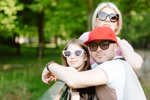 Portrait of enjoy happy love family father and mother are holding cute girl. Family are having fun moments good time in summer park.