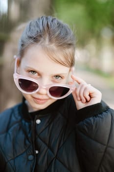 Funny girl playing outdoor surprised emotional child in sunglasses 11 years old girl, family vacations.