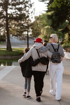 Family photo walking together in the park.