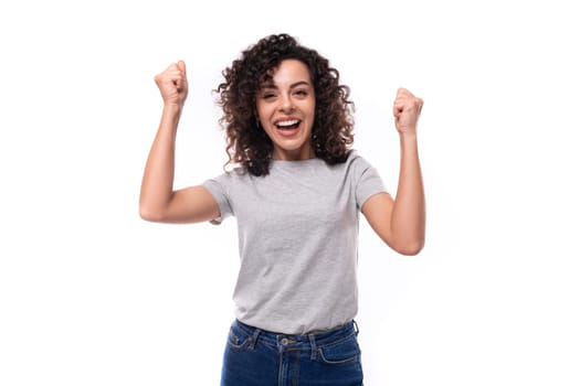 portrait of a young joyful 30 year old caucasian woman in a gray t-shirt with a mockup for printing on a white background with copy space.