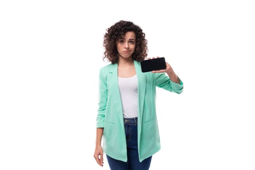 caucasian young leader woman with curly black hair shows phone screen.
