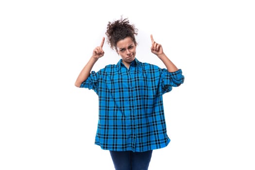 young smart woman dressed in casual shirt shows index finger up.