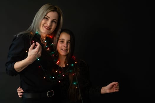 family with garland at night at home.