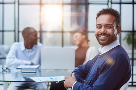 Portrait of African American businessman sitting at desk in an office