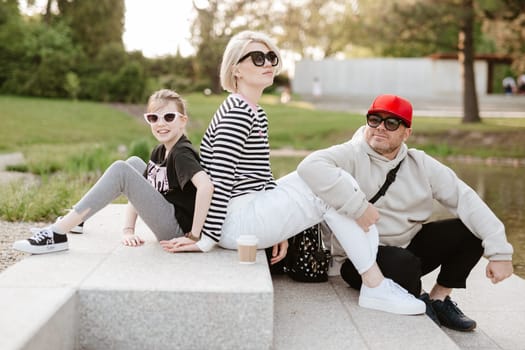 Young family with their daughter at park having fun together.