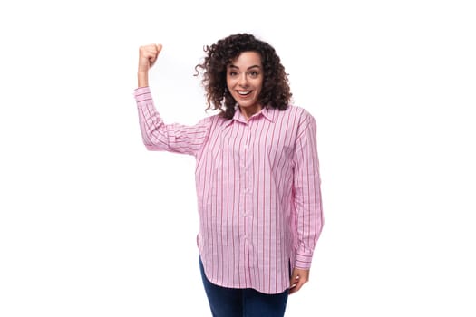 young curly brunette model woman wearing a pink striped shirt.