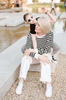 Mother hugging with her daughter outdoor in nature