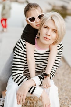 Mother hugging with her daughter outdoor in nature