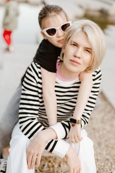 Mother hugging with her daughter outdoor in nature