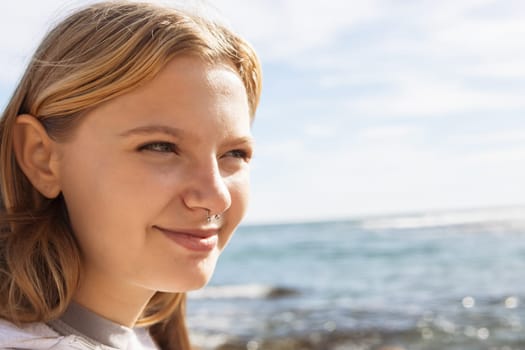 portrait of a teenage girl with a nose piercing against the background of the sea. High quality photo