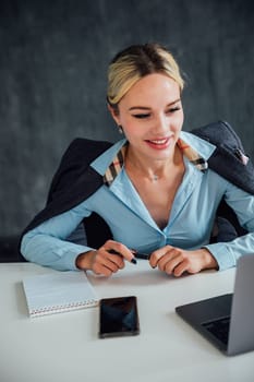 woman working in office on laptop programmer